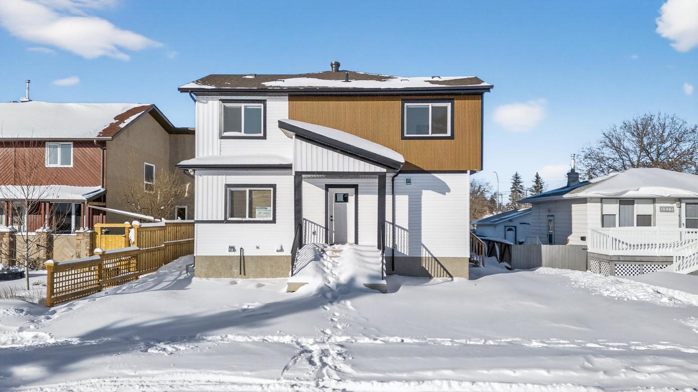 A new two-storey infill with a basement suite on a snowy west Edmonton street
